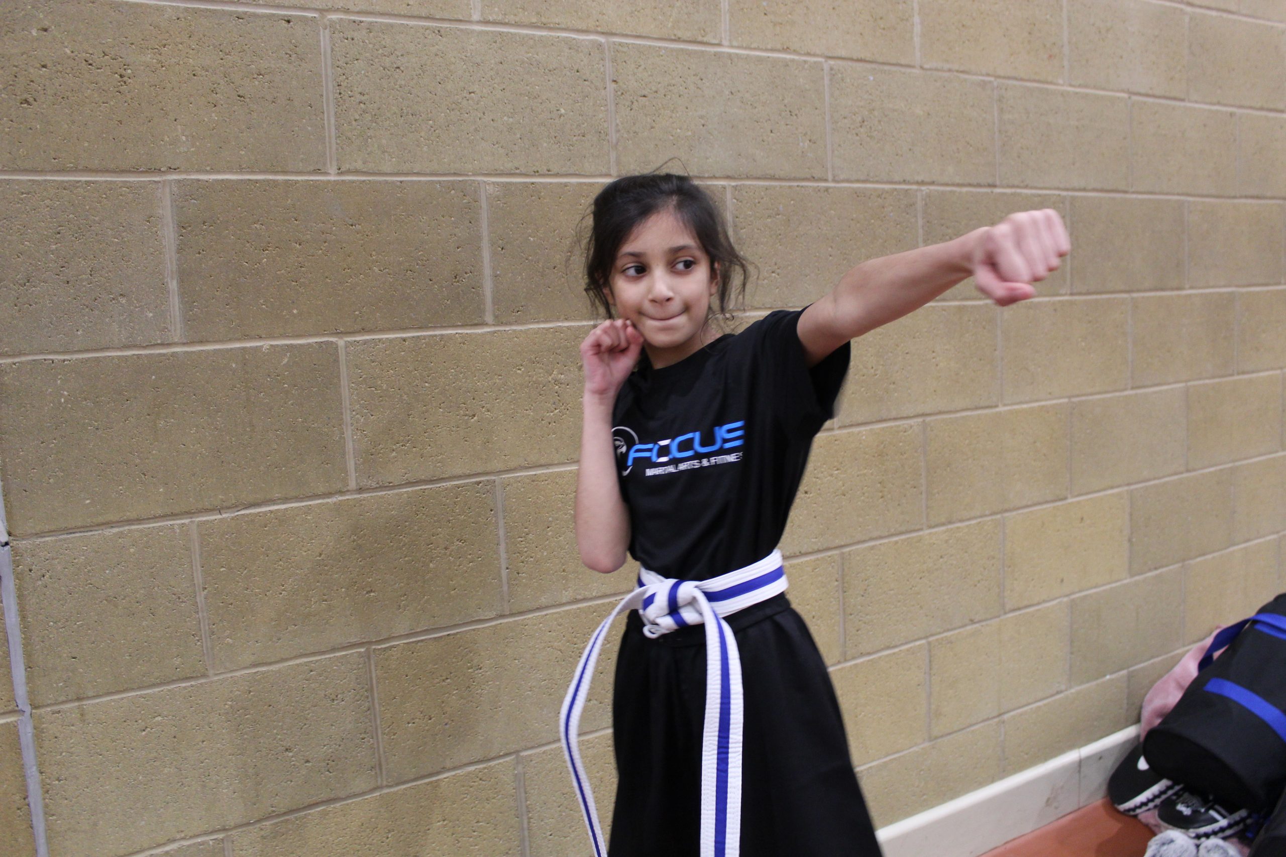 A young Focus Fitness student practising a punch