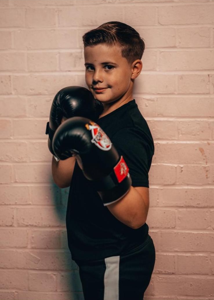 A young student in Focus kit with his boxing gloves