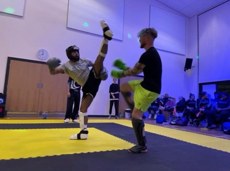 A high kick during a sparring competition