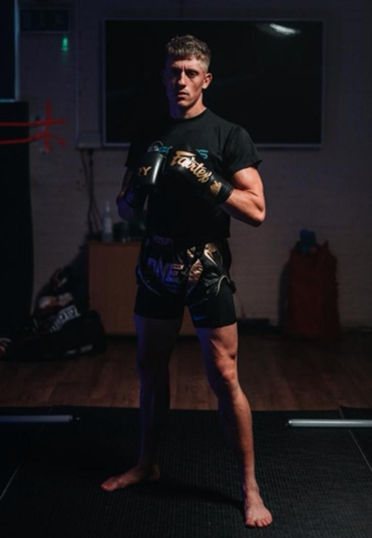 An adult member in full Muay Thai kit