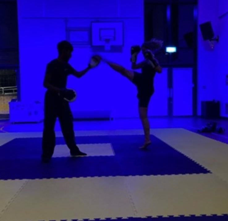 A high kick on the pads during an evening session